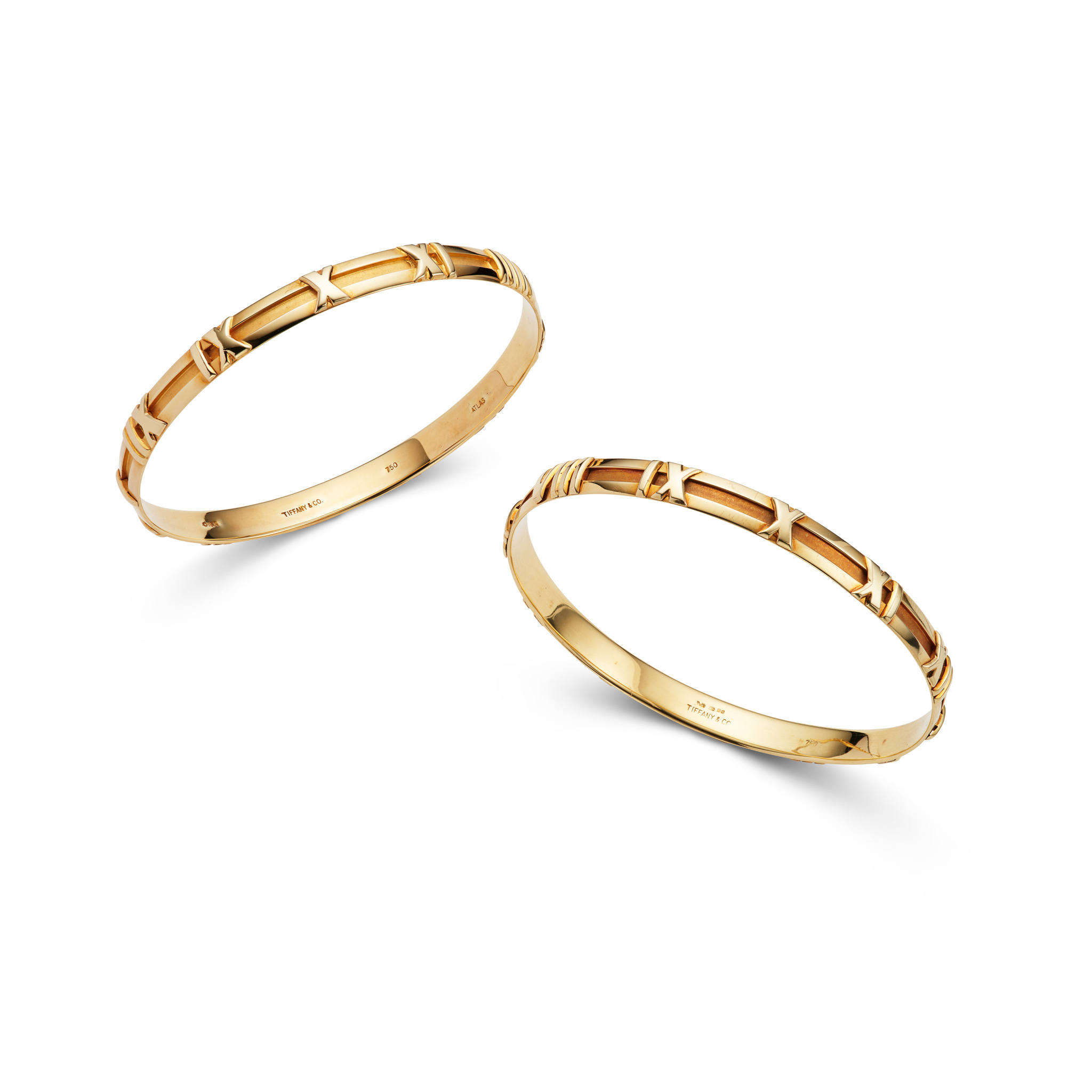 Tiffany & Co.: A pair of gold 'Atlas' bangles