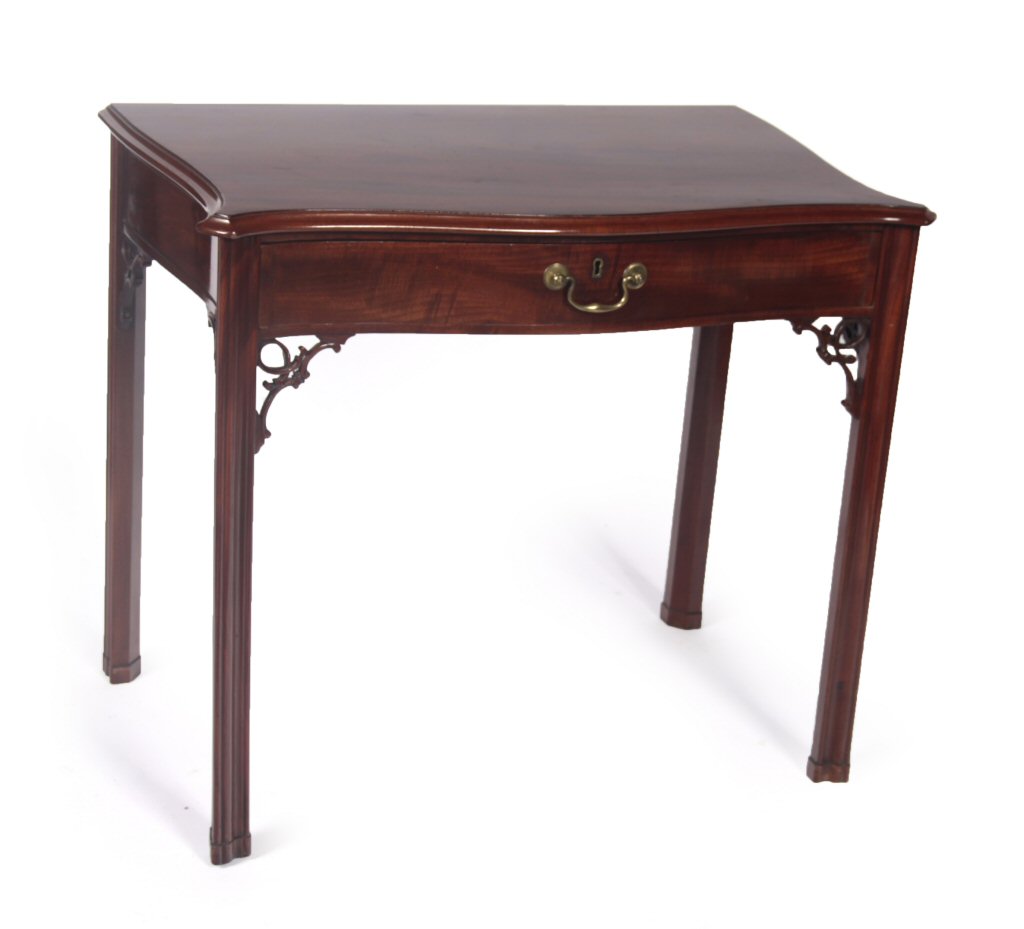A Georgian style mahogany serpentine writing table