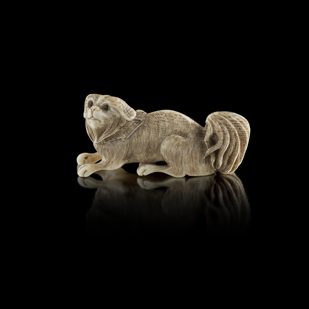 IVORY OKIMONO OF A JAPANESE CHIN