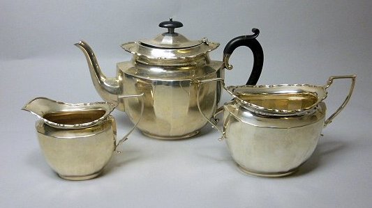 A modern three piece silver tea set