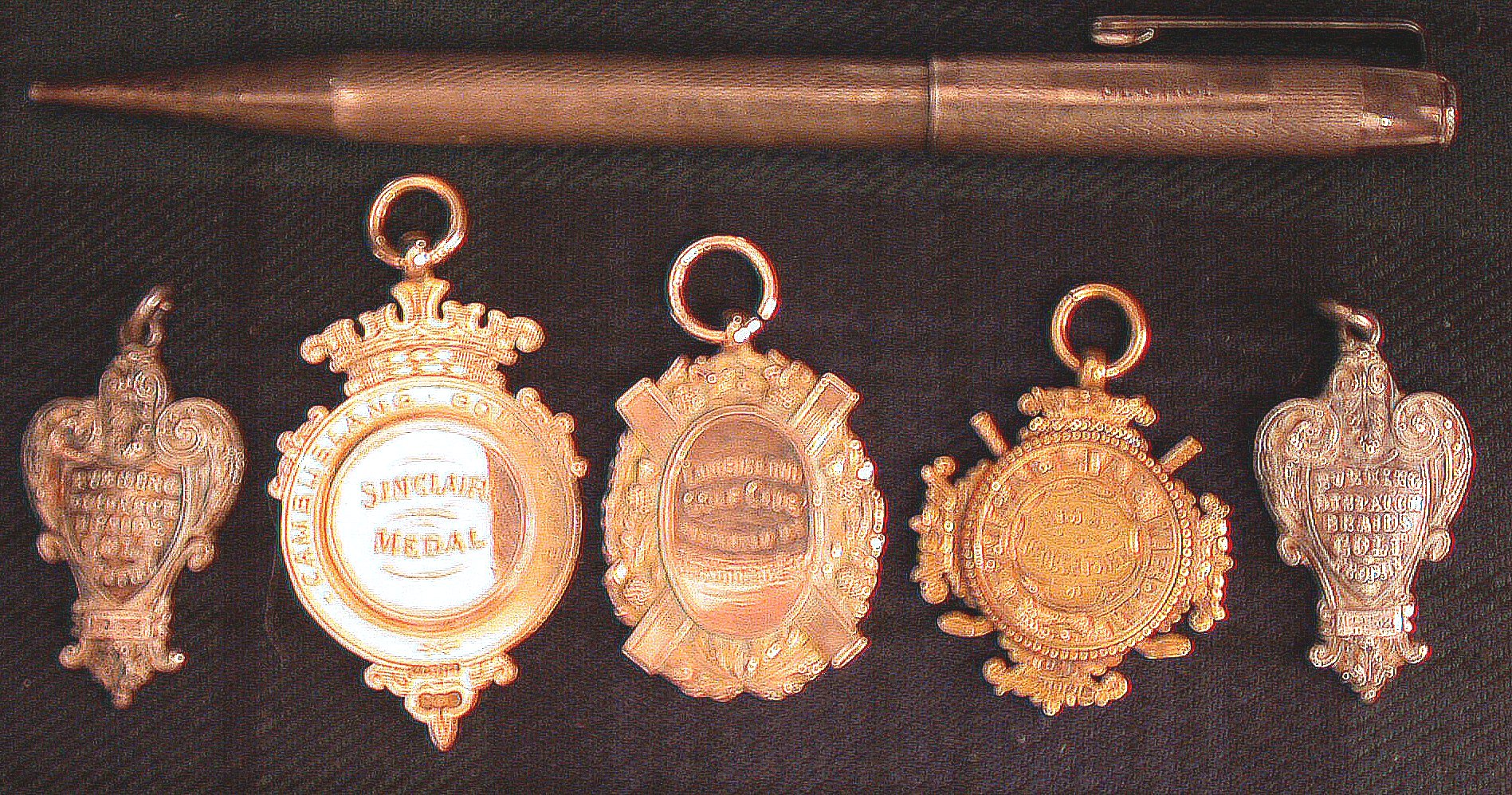 A cast silver, trophy shaped golfing medal,