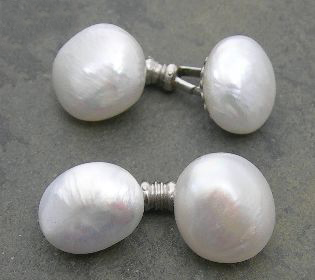 A pair of platinum mounted bouton pearl set cufflinks