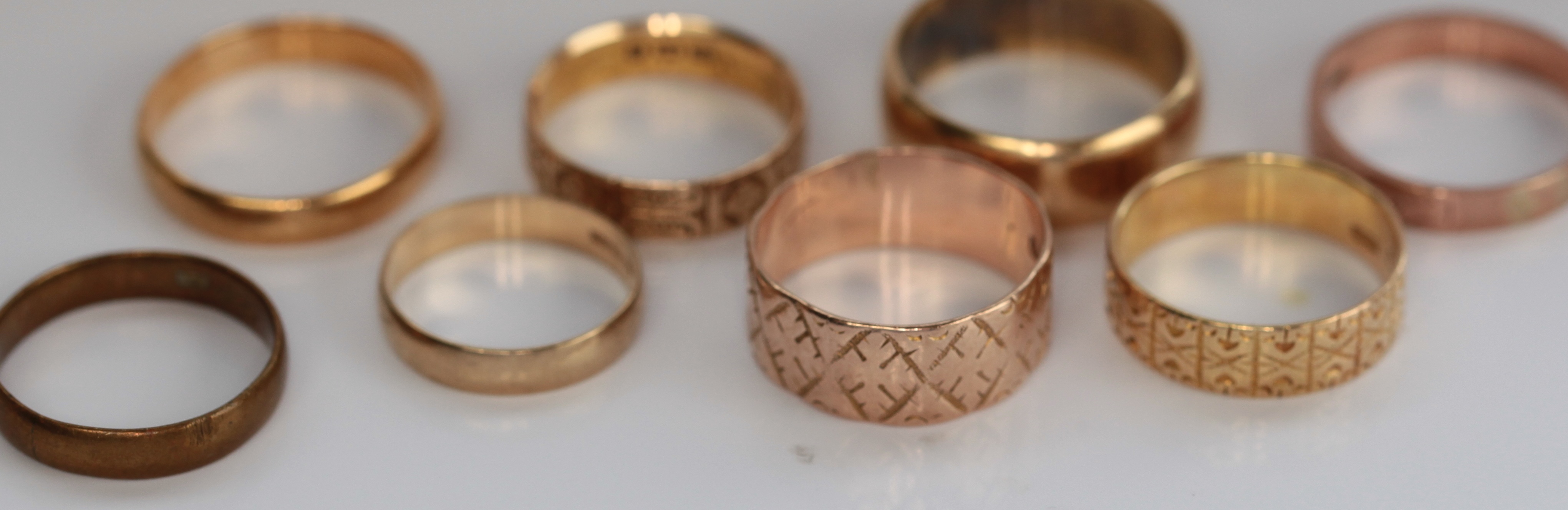 A group of gold wedding bands