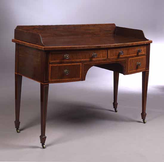 An Edwardian mahogany bow front dressing table