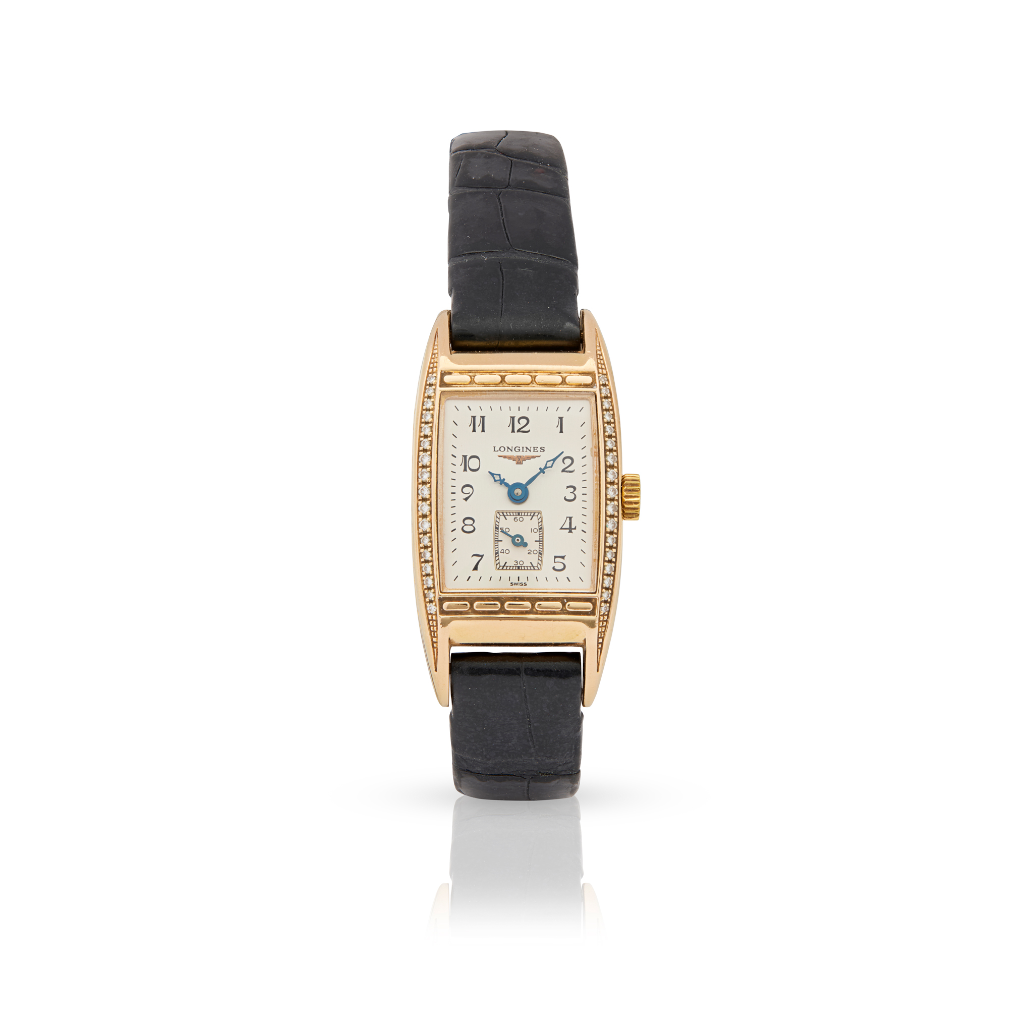 Longines. A Ladies 18k gold and diamond tonneau shape quartz wristwatch