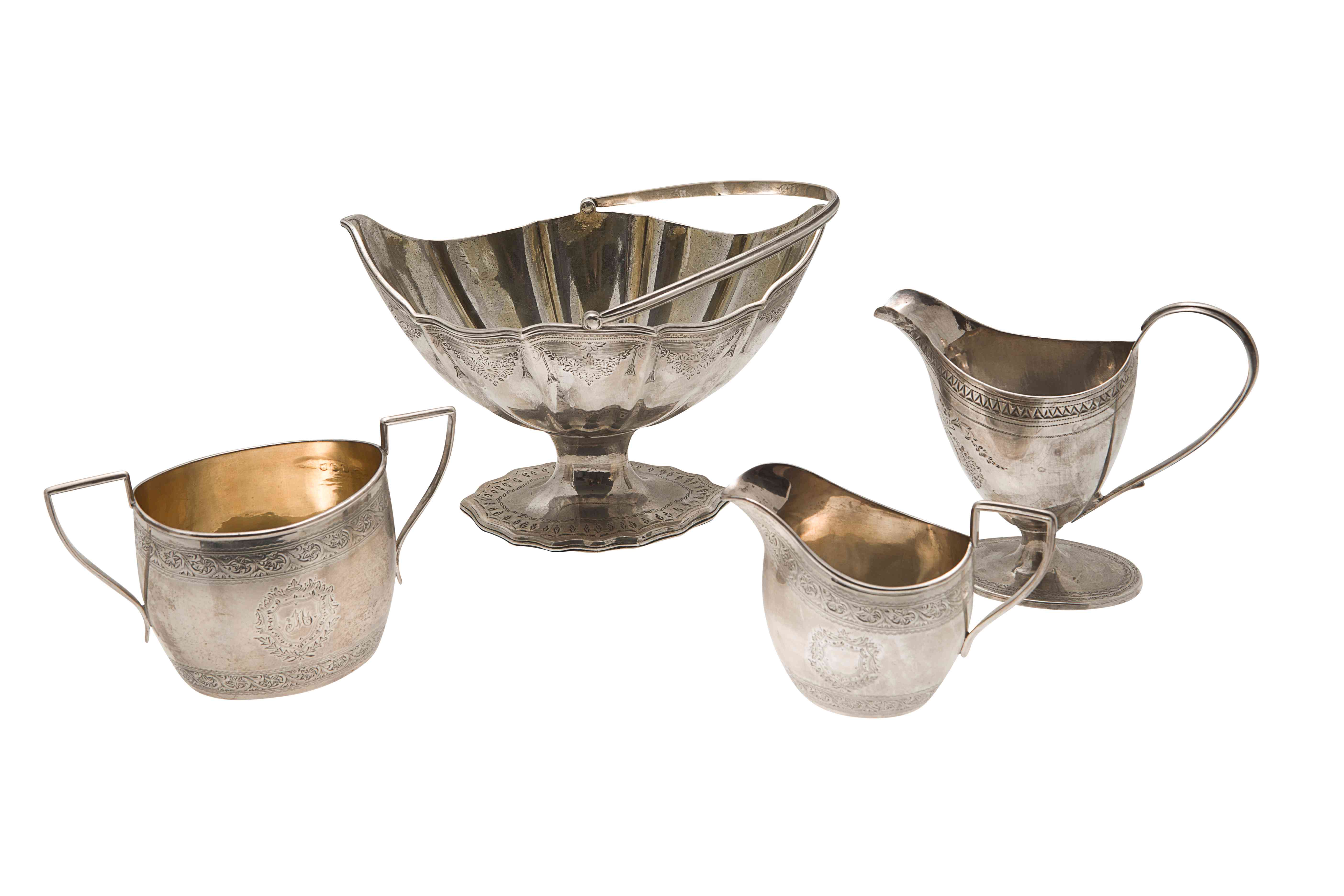 A group of four George III and other bright cut tea wares