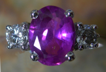 An 18ct white gold mounted pink sapphire and diamond set ring,