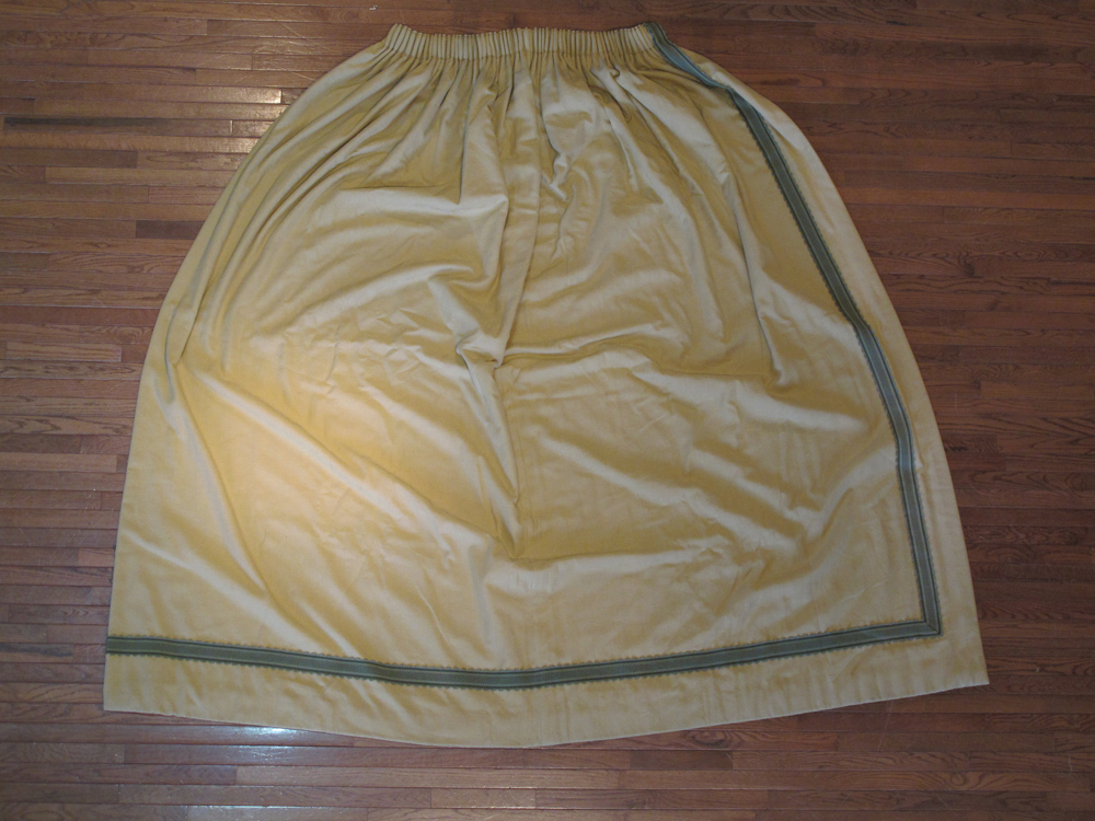 A pair of handmade beige curtains with pelmet