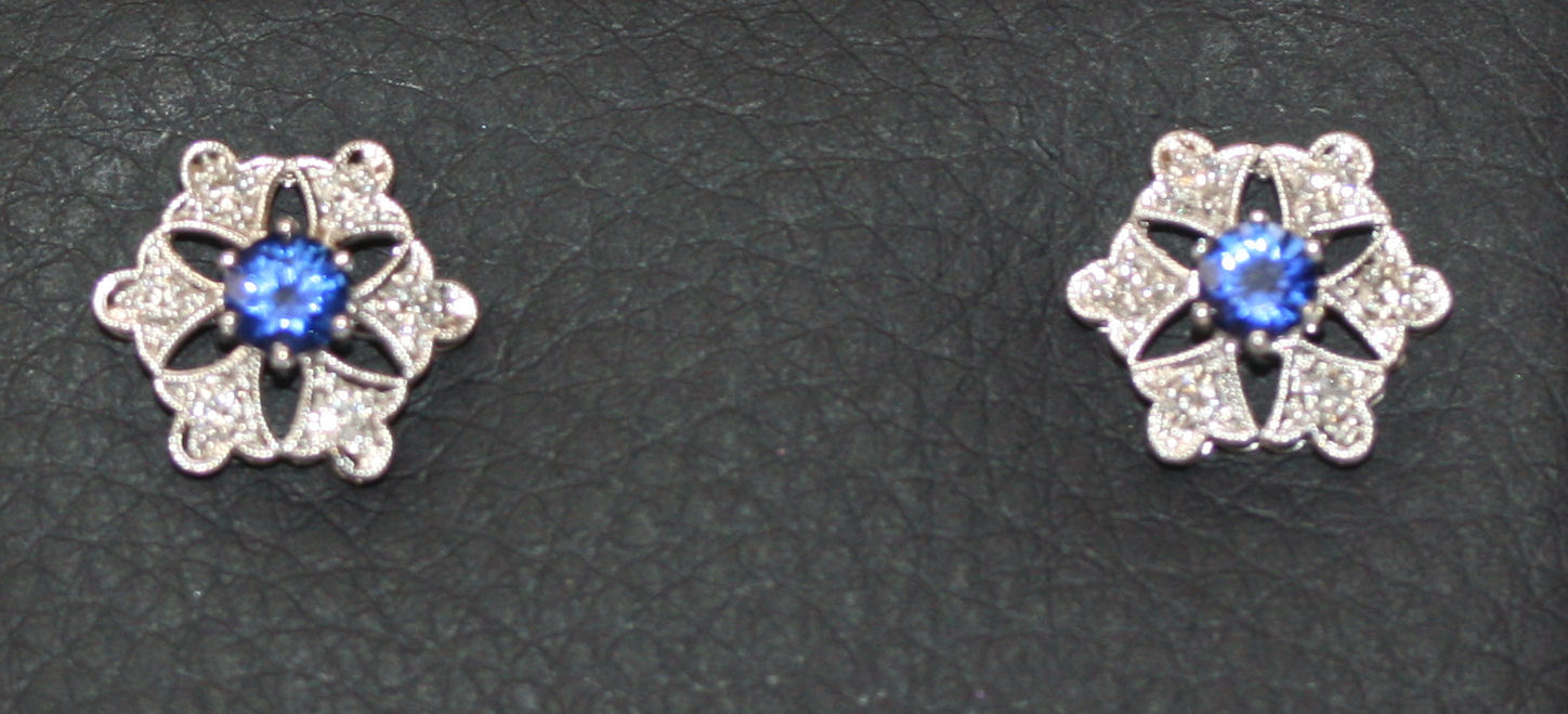 A contemporary pair of sapphire and diamond set cluster earrings
