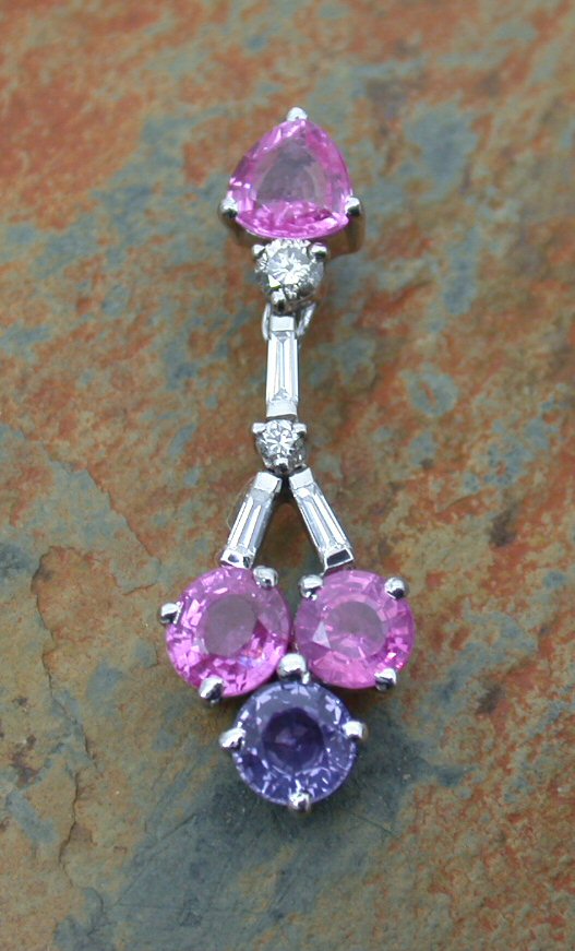 A pink and purple sapphire and diamond pendant,
