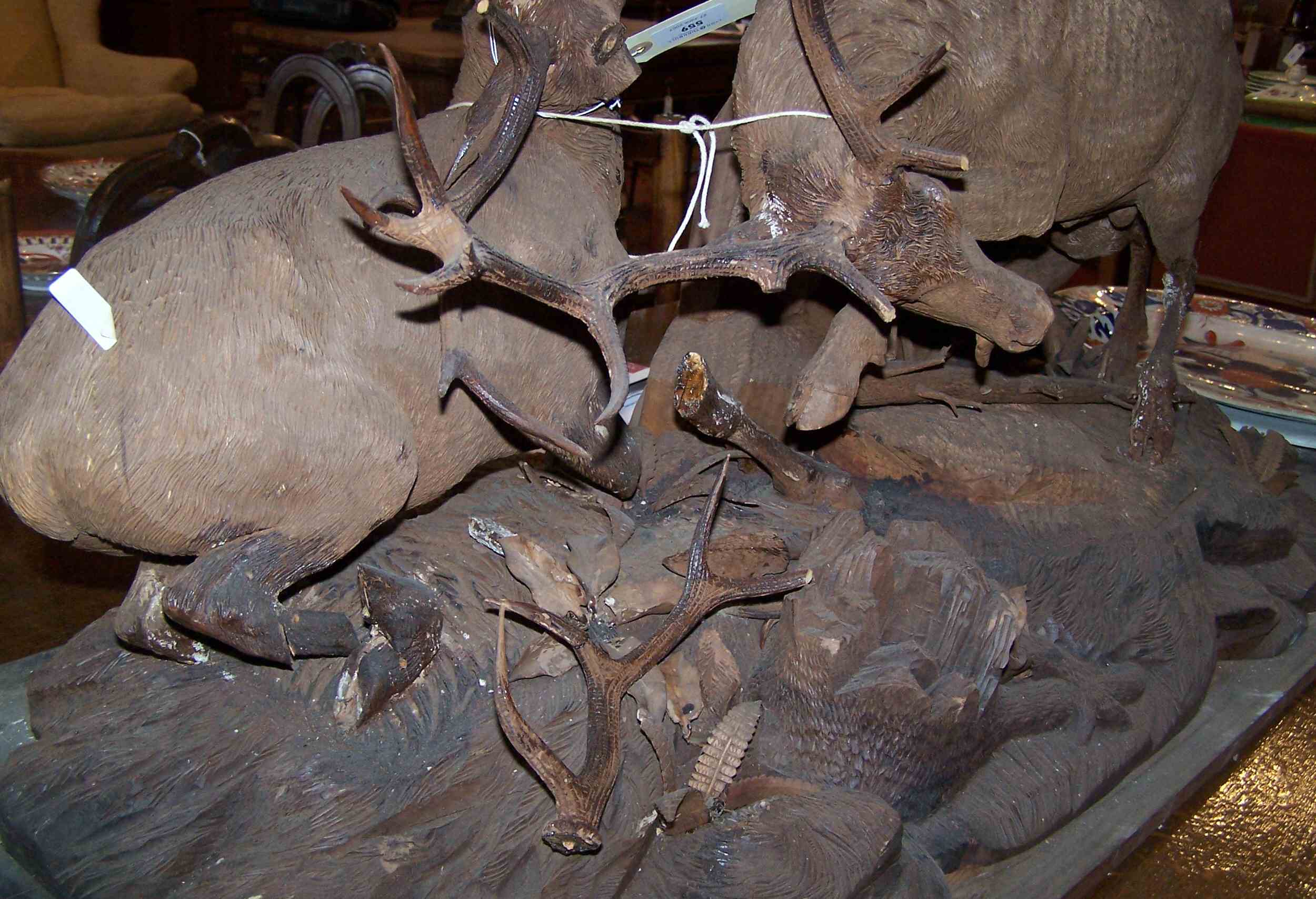 A 19th century Swiss carved walnut group of fighting stags