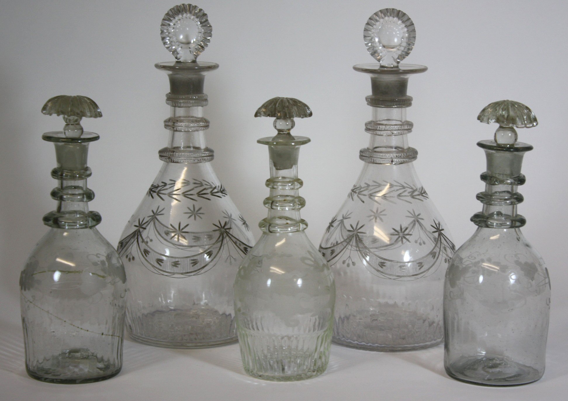 GROUP OF FIVE IRISH GLASS DECANTERS