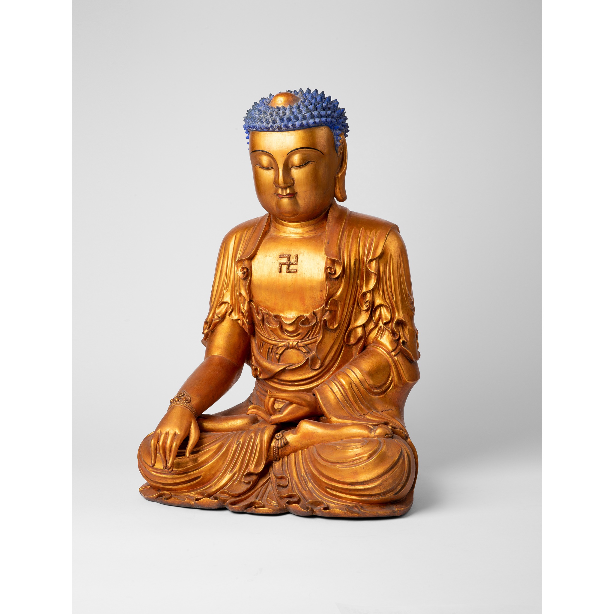 LARGE GILT-LACQUERED WOOD FIGURE OF SHAKYAMUNI