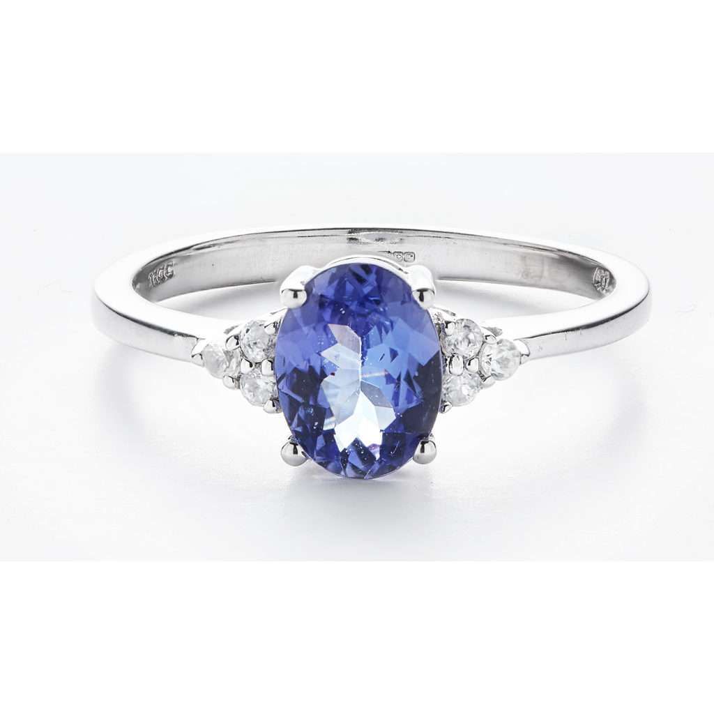 A three stone Tanzanite and zircon set ring