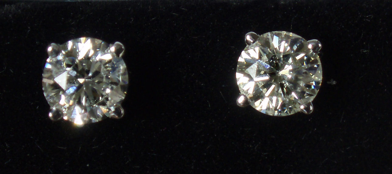A pair of 18ct white gold mounted diamond set earrings,