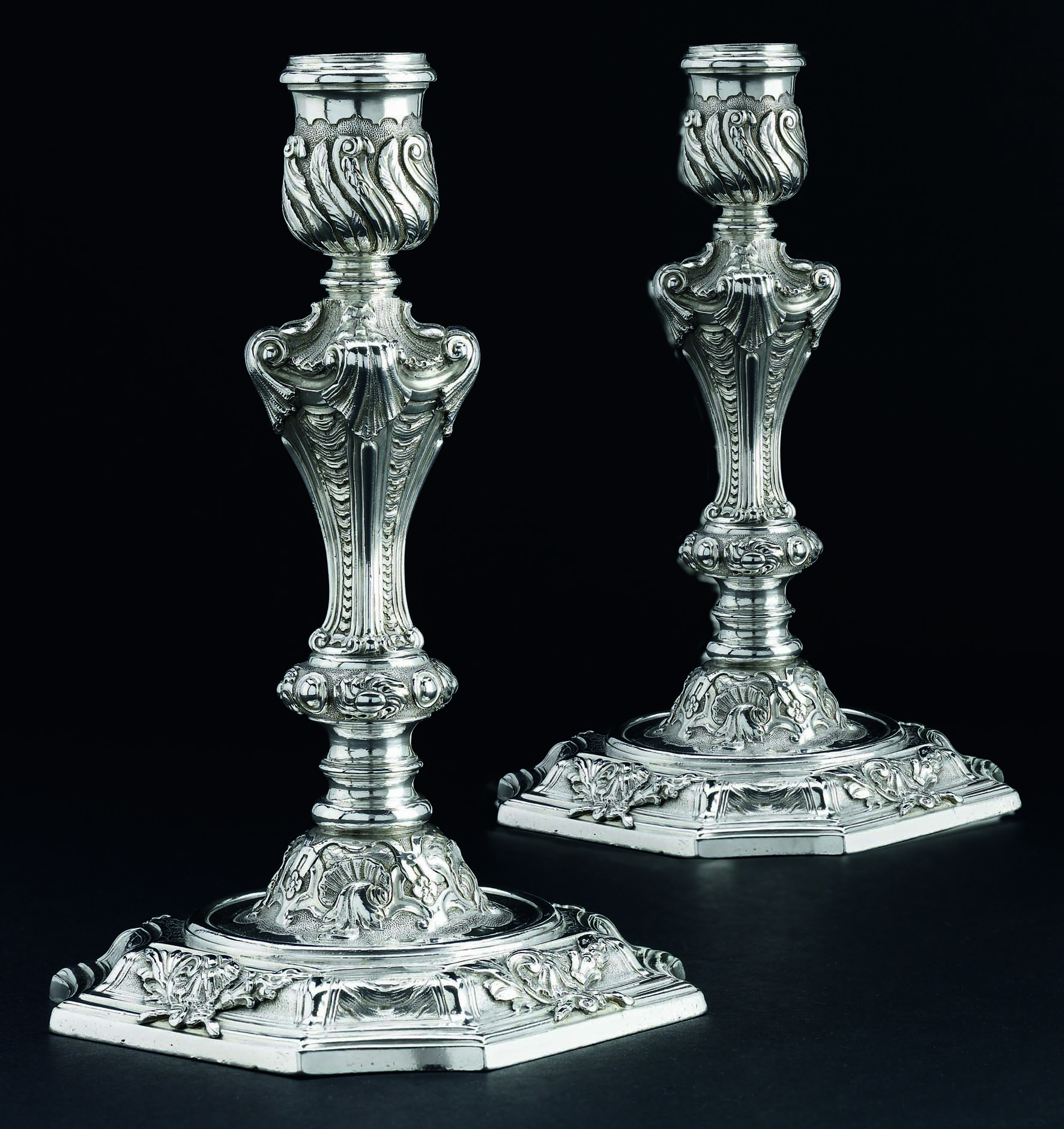 An important pair of George II silver candlesticks