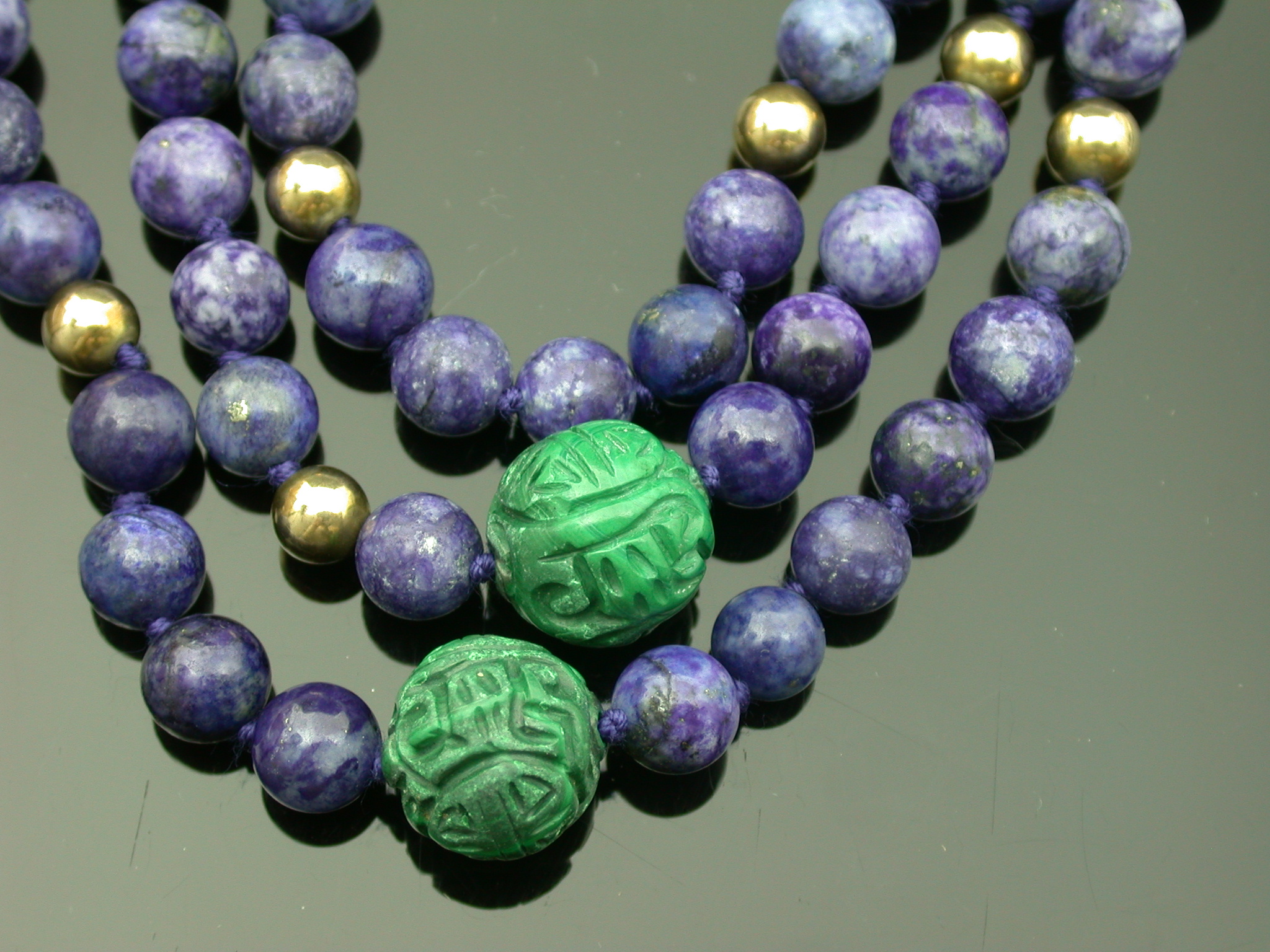 A lapis lazuli, malachite and gold bead necklace,