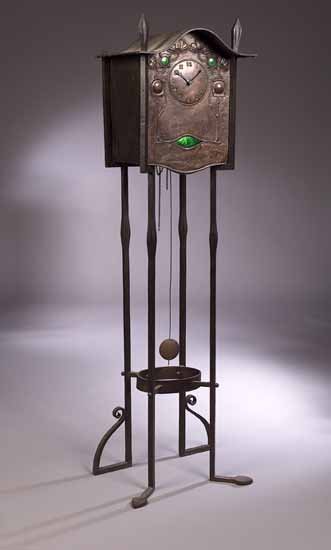 A Scottish School wrought iron framed standing clock