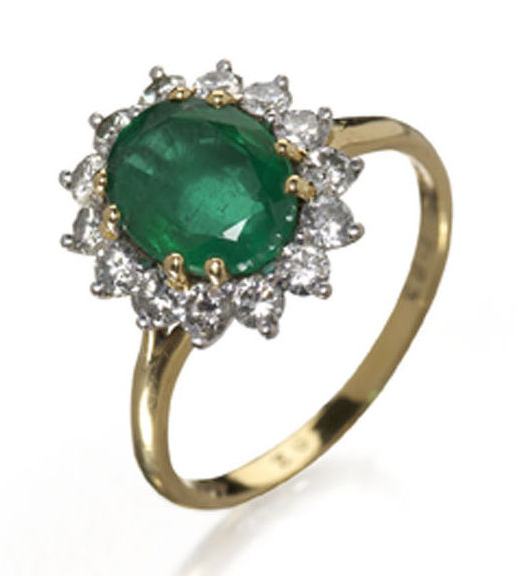 An 18ct gold mounted emerald and diamond oval cluster ring,