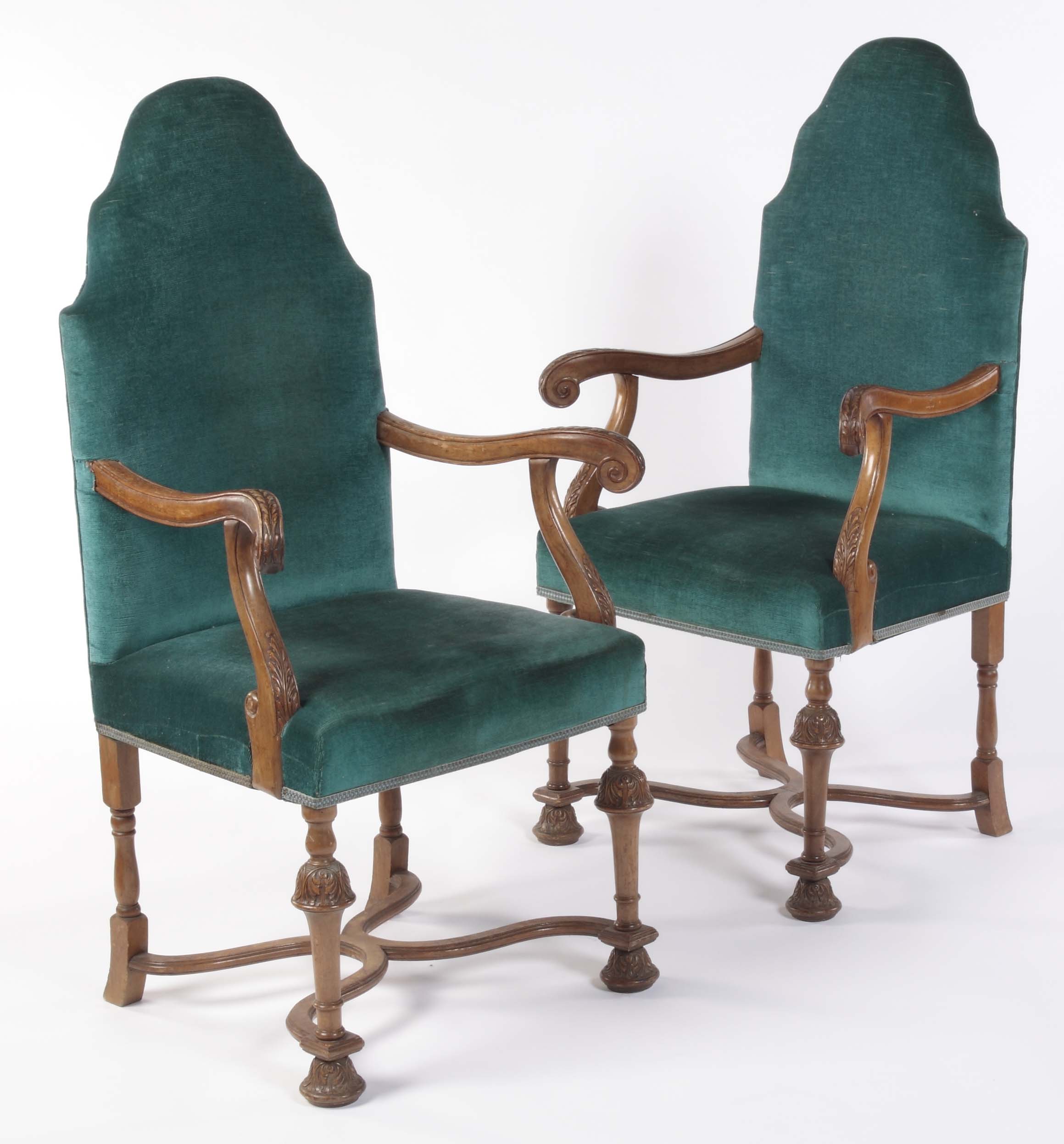 A pair of walnut framed high back armchairs In the William and Mary manner