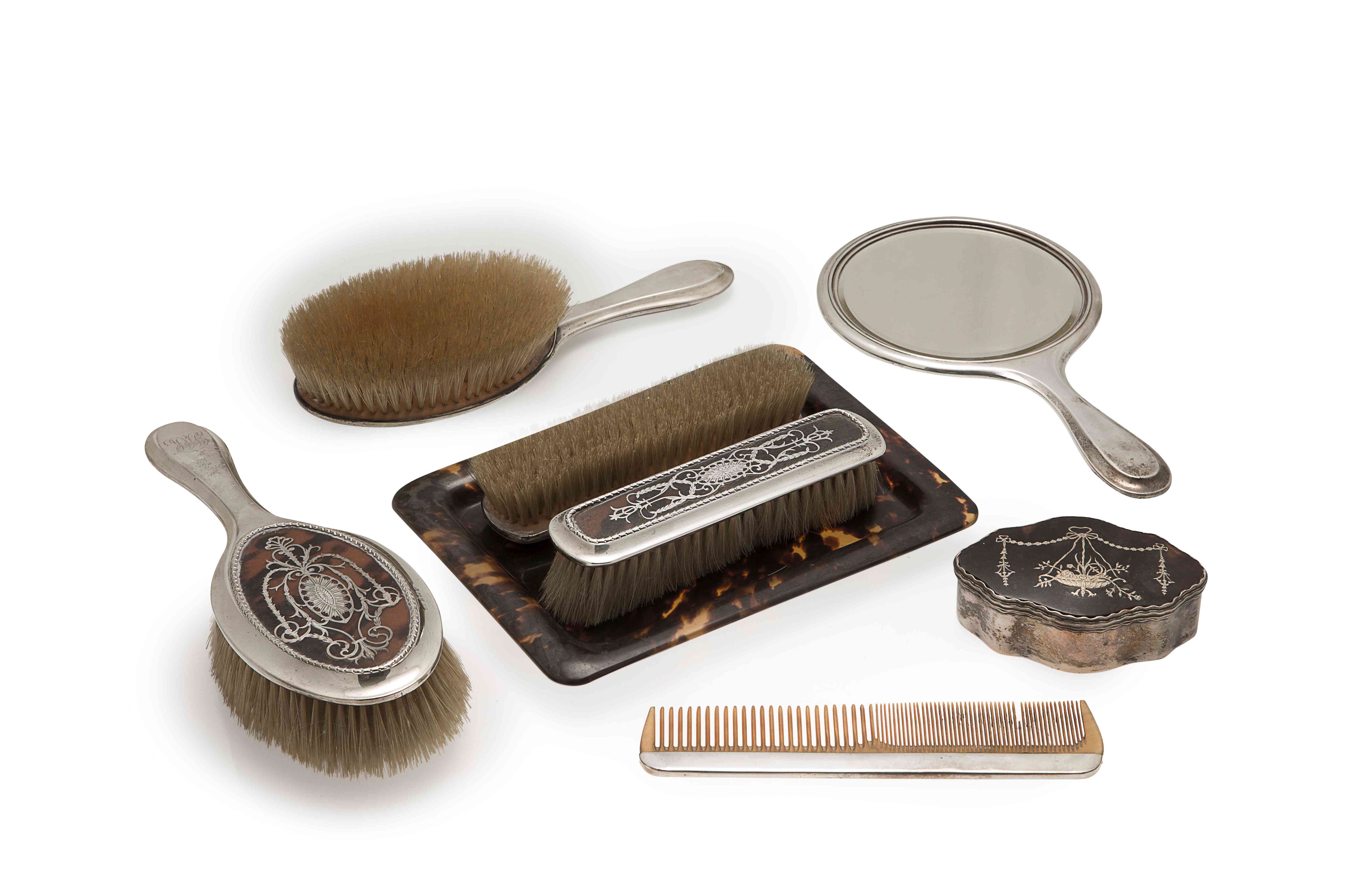 An Edwardian silver and tortoiseshell brush set