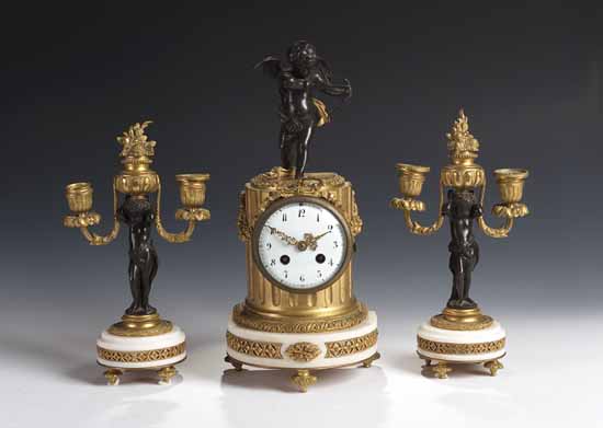 A gilt brass clock garniture