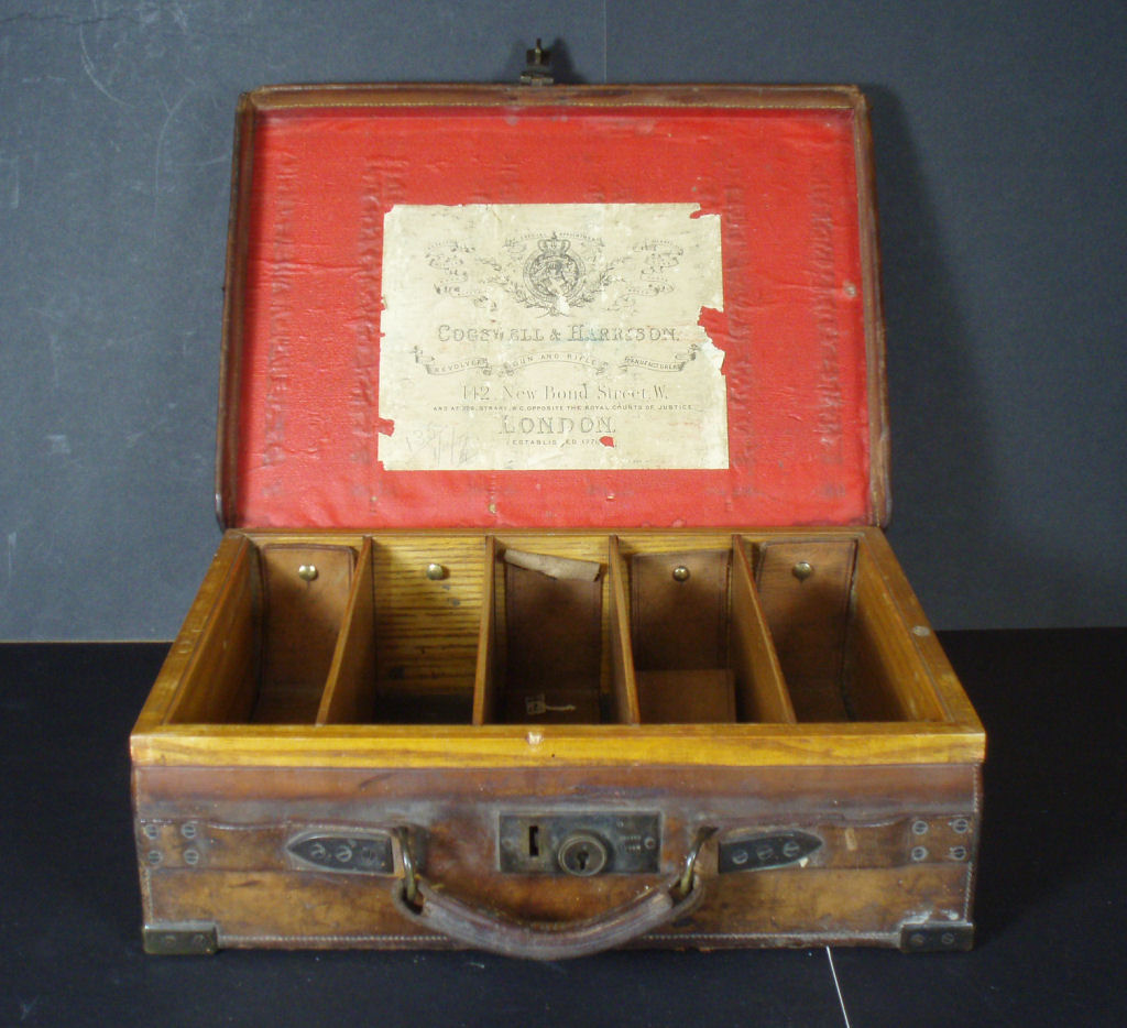 An early 20th century oak and leather cartridge magazine box