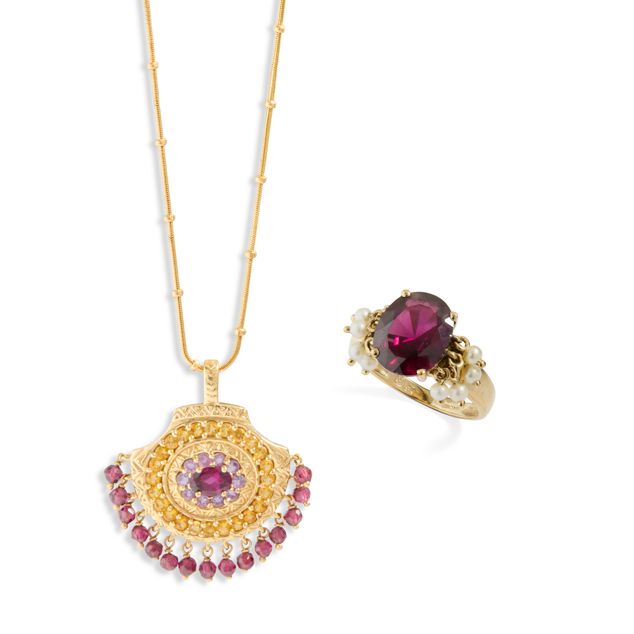 A 9ct gold garnet drop pendant necklace and a garnet and seed pearl ring