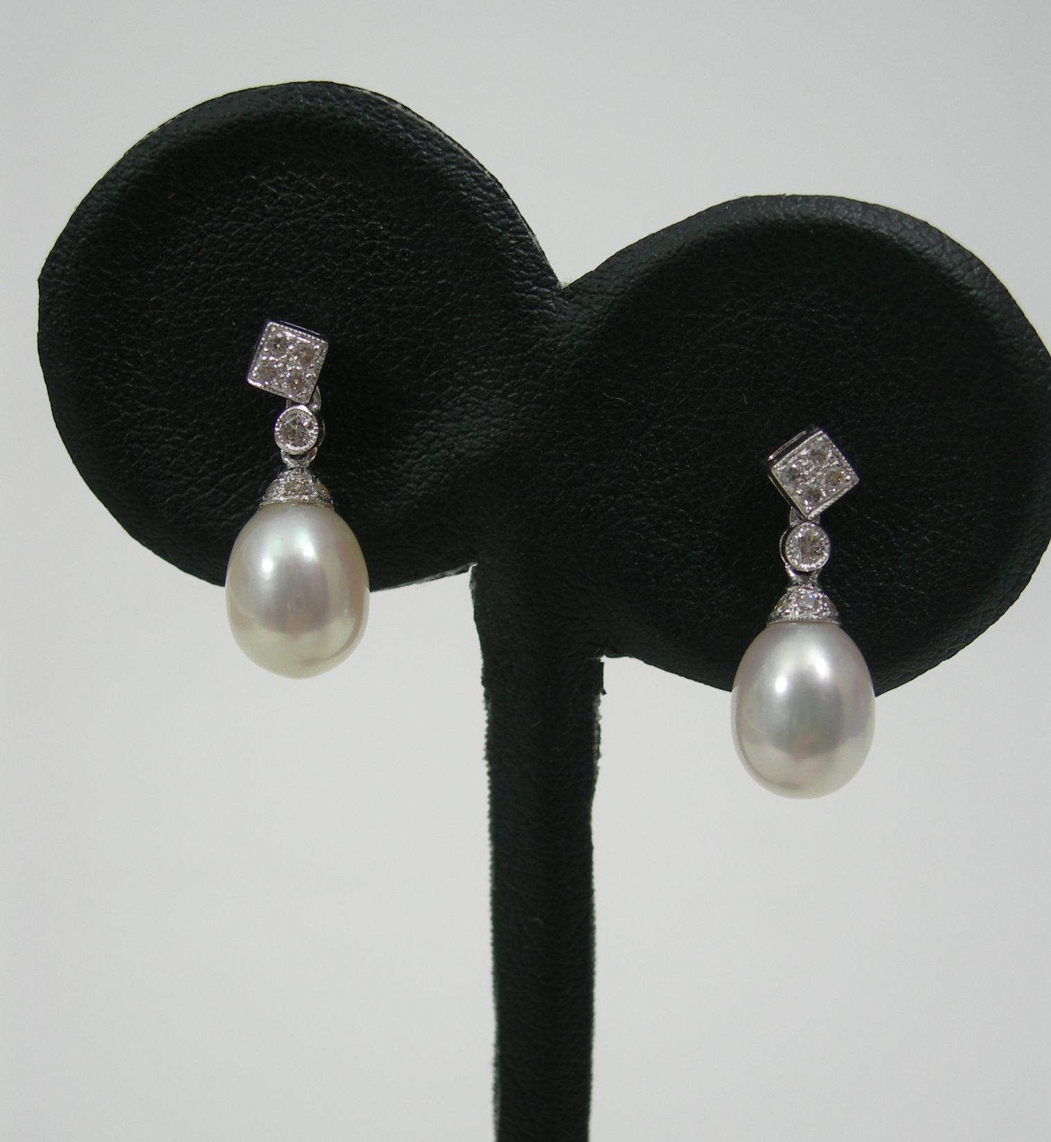 A pair of cultured pearl and diamond pendant earrings,