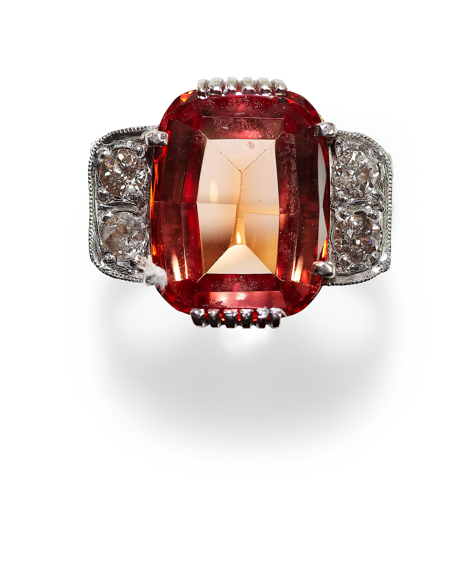 An 18ct gold mounted synthetic reddish-orange sapphire and diamond set ring