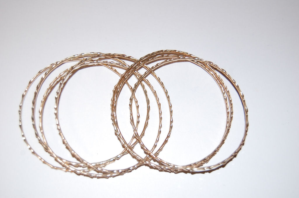 A set of seven 9ct gold bangles,
