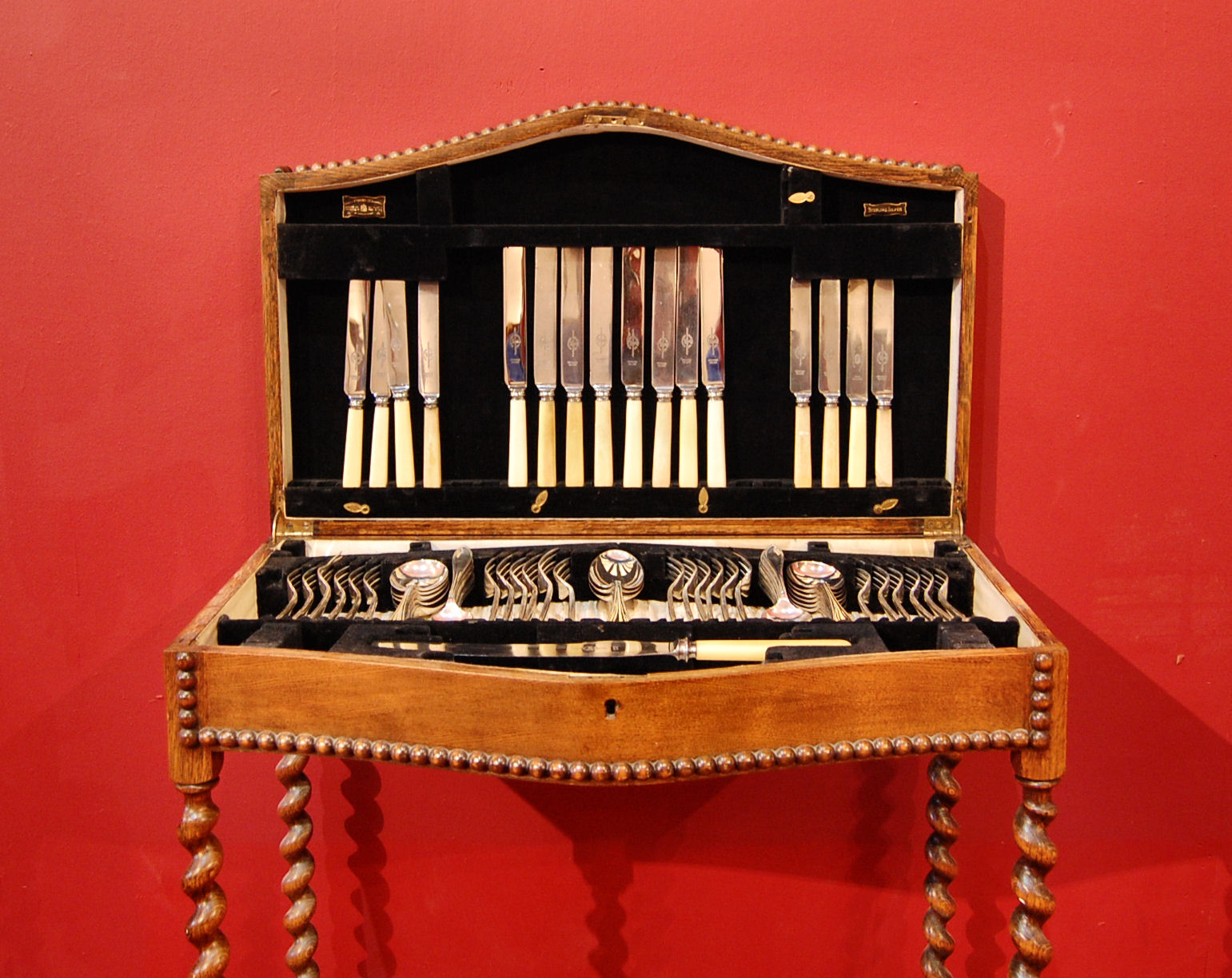 An oak cased table canteen of silver cutlery