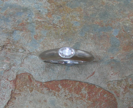 A platinum mounted diamond single-stone ring,