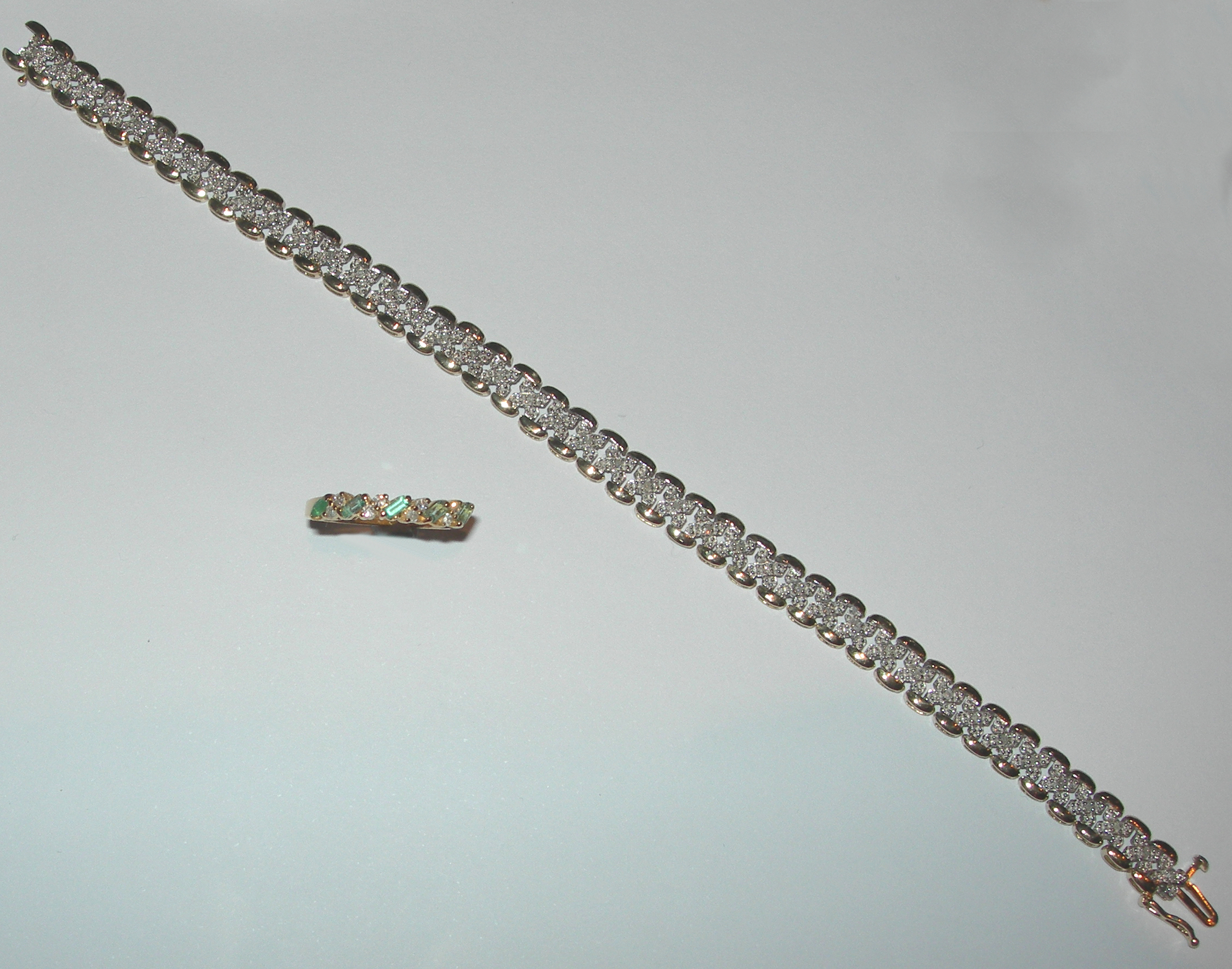 An 18ct gold mounted emerald and diamond set ring,