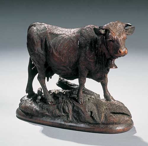 A 19th century Black Forest carved figure of a cow