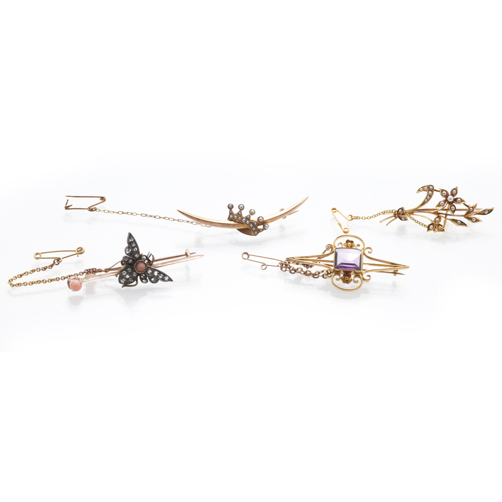 A collection of gem set brooches