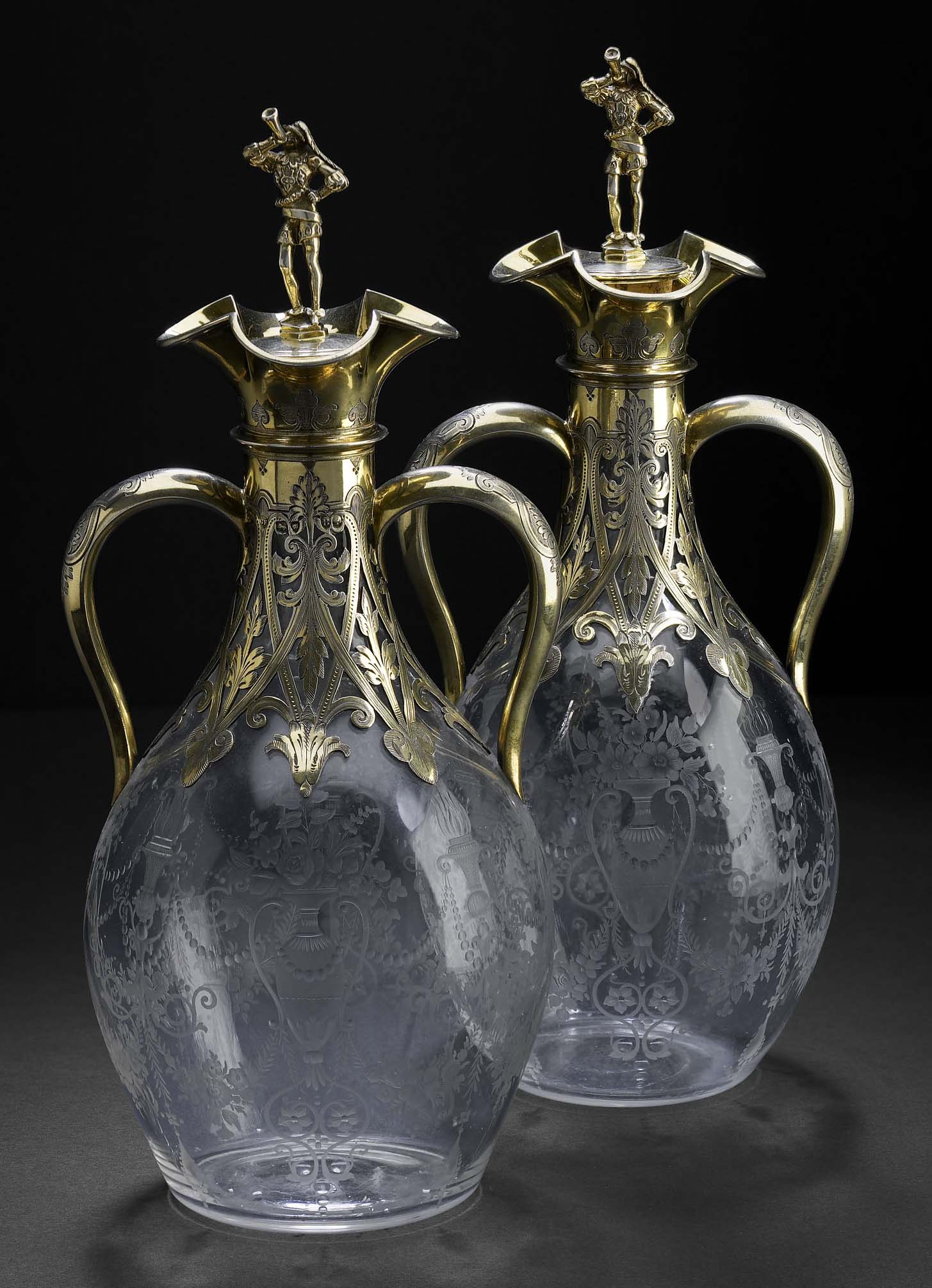 A pair of Victorian silver-gilt mounted glass decanters
