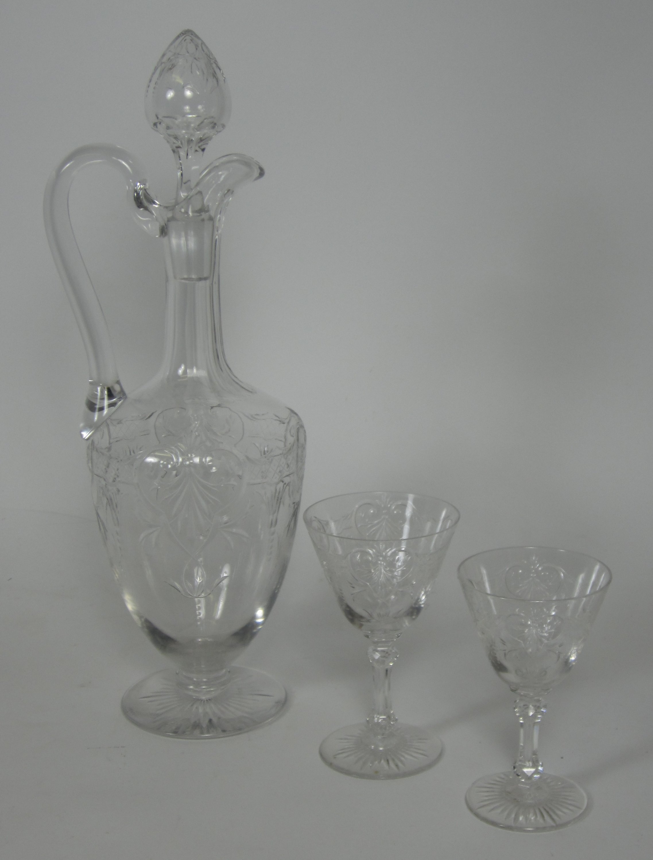 PART SUITE OF CUT CRYSTAL GLASSES AND DECANTERS