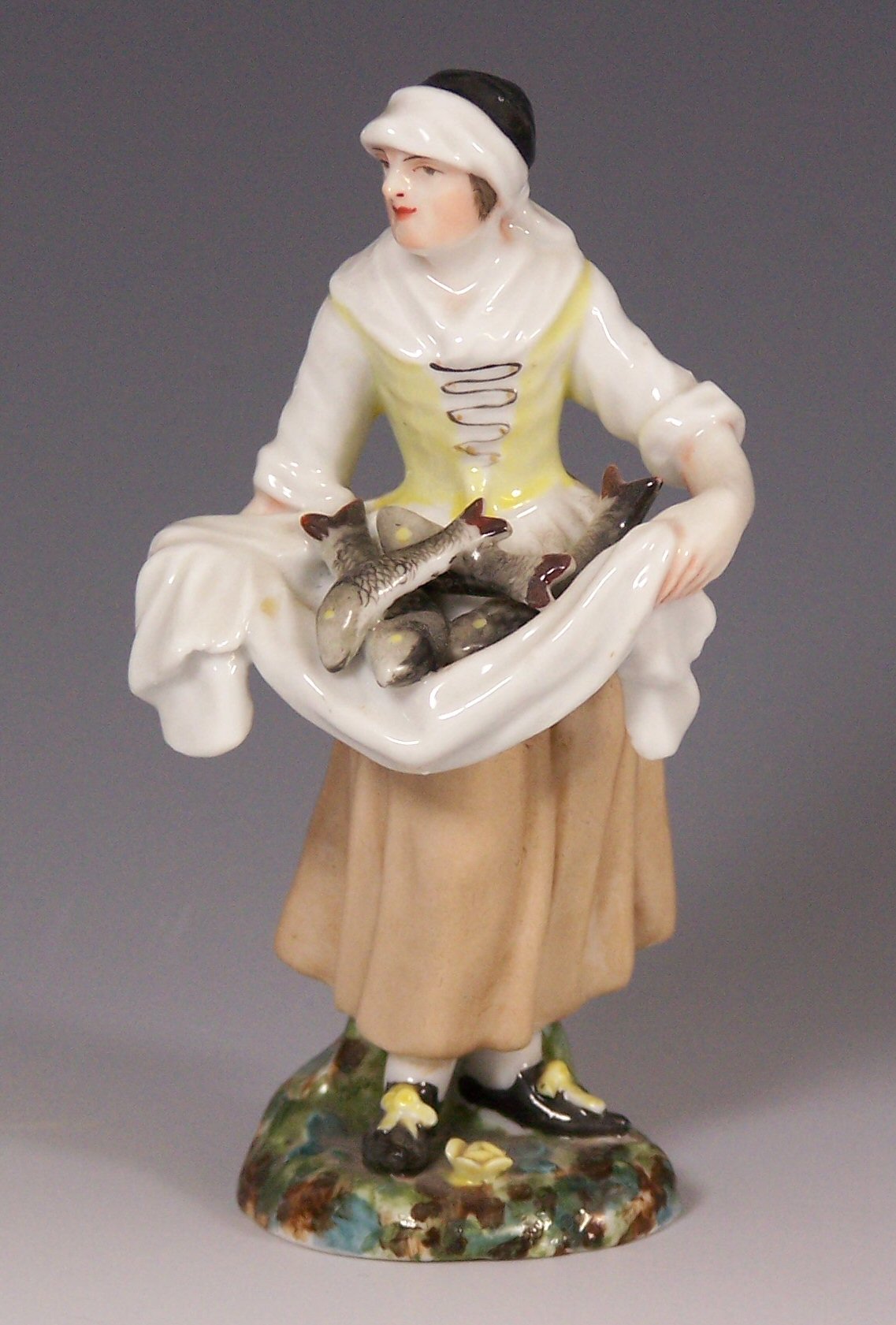 A 19th century Russian Popoff figure of a fisherwoman,