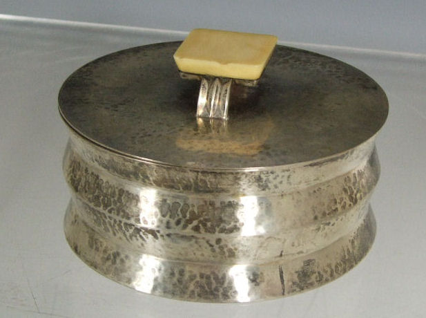 A Continental Art Deco hammered white metal dish and cover