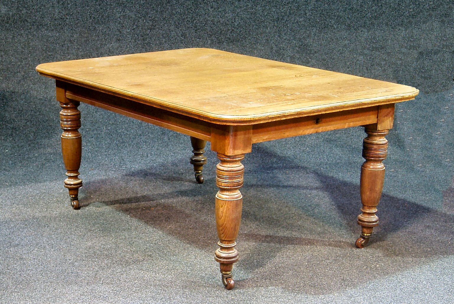 A Victorian extending oak dining table,