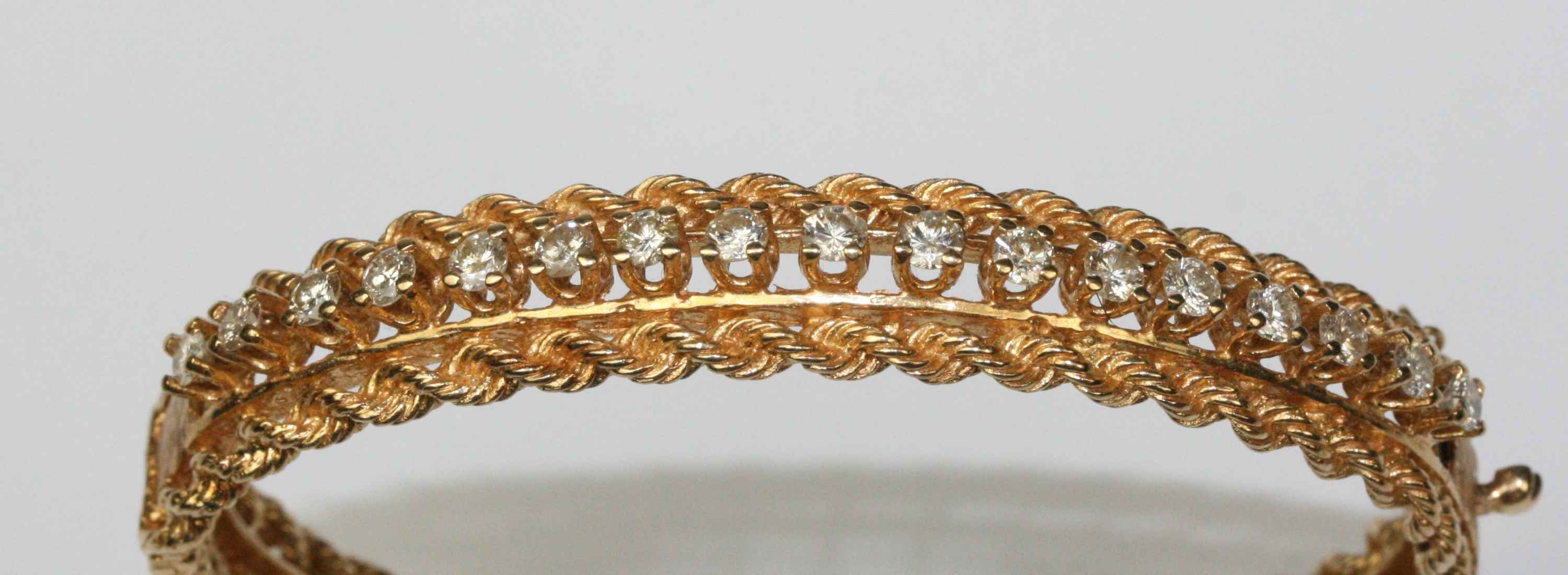 A diamond set hinged bangle