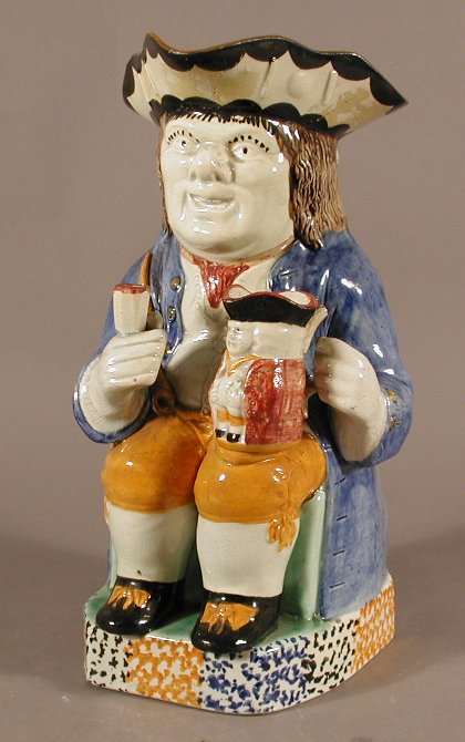 An English pottery toby jug and lid