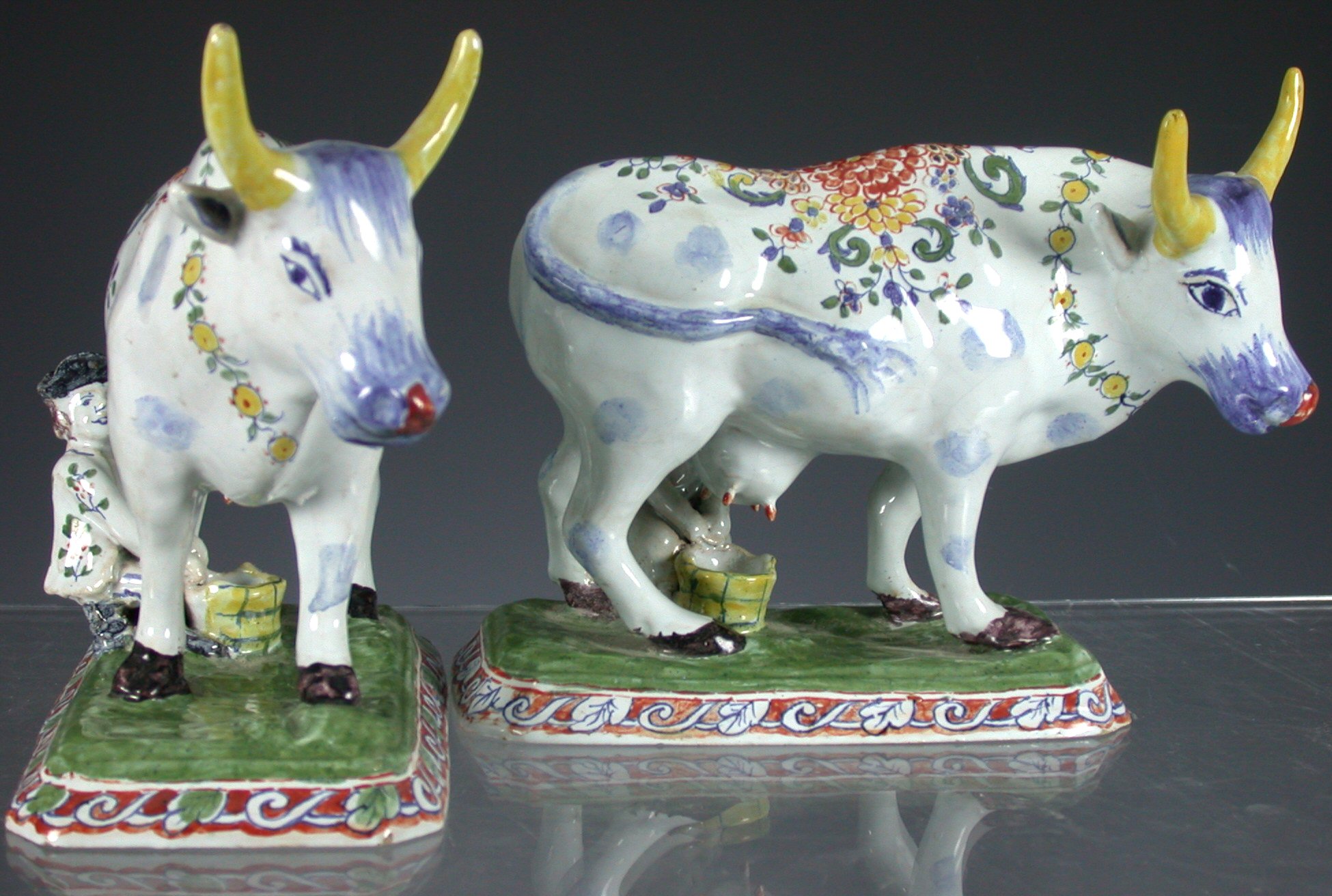 A pair of 19th century Dutch Delft figures of cows,