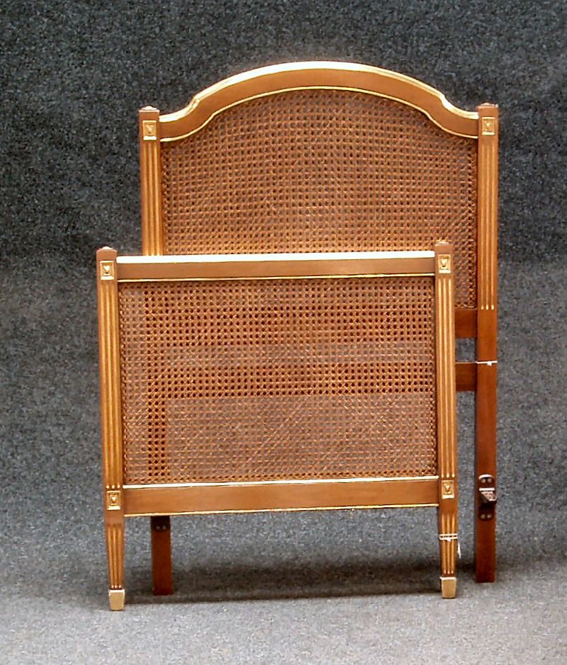 A pair of caned bed ends
