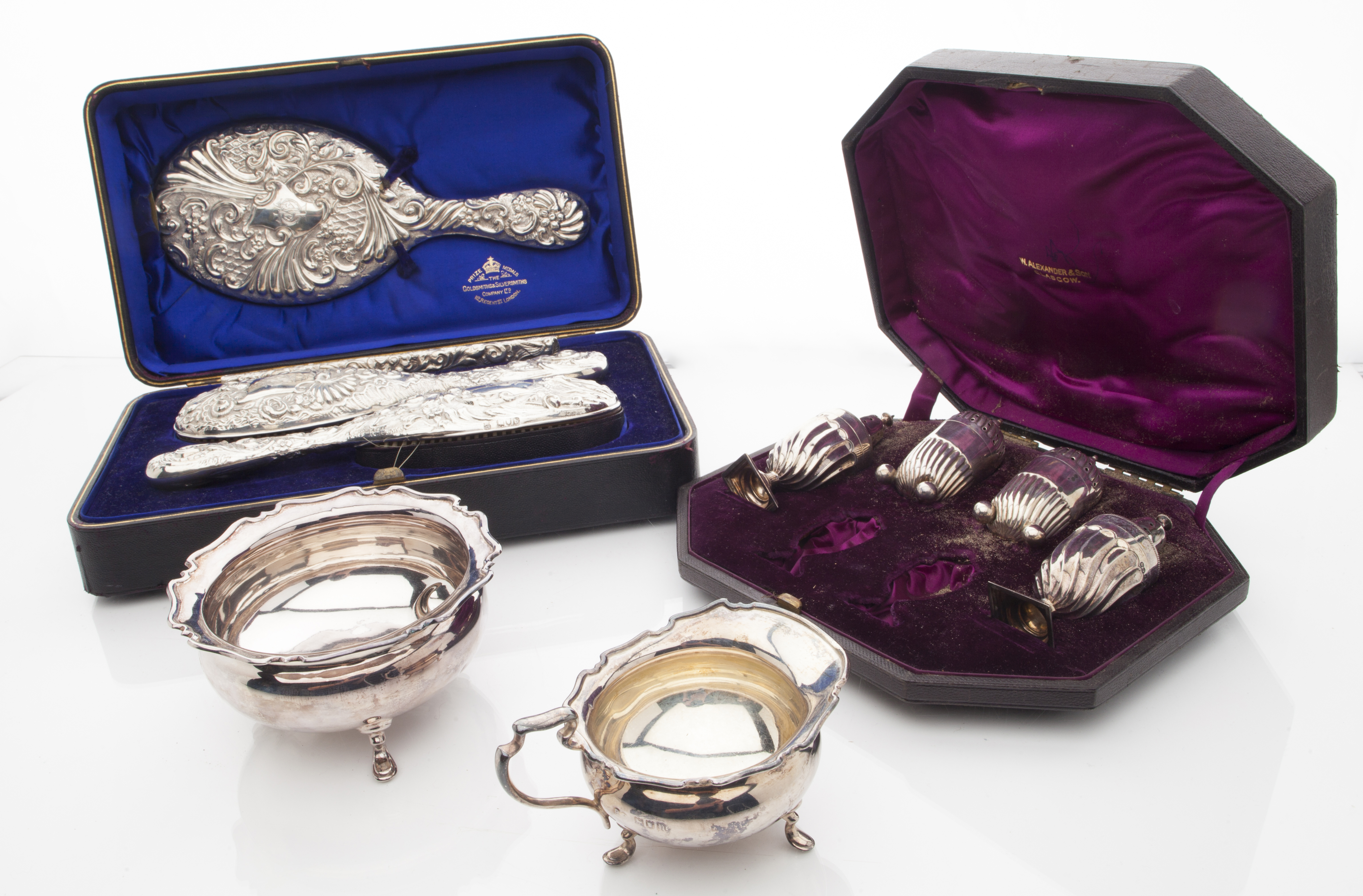 A cased four piece dressing table set