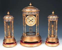 A French 19th century gilt and champleve clock garniture