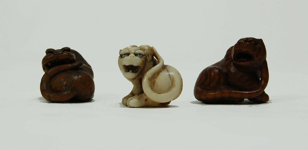 A group of three carved Japanese netsuke