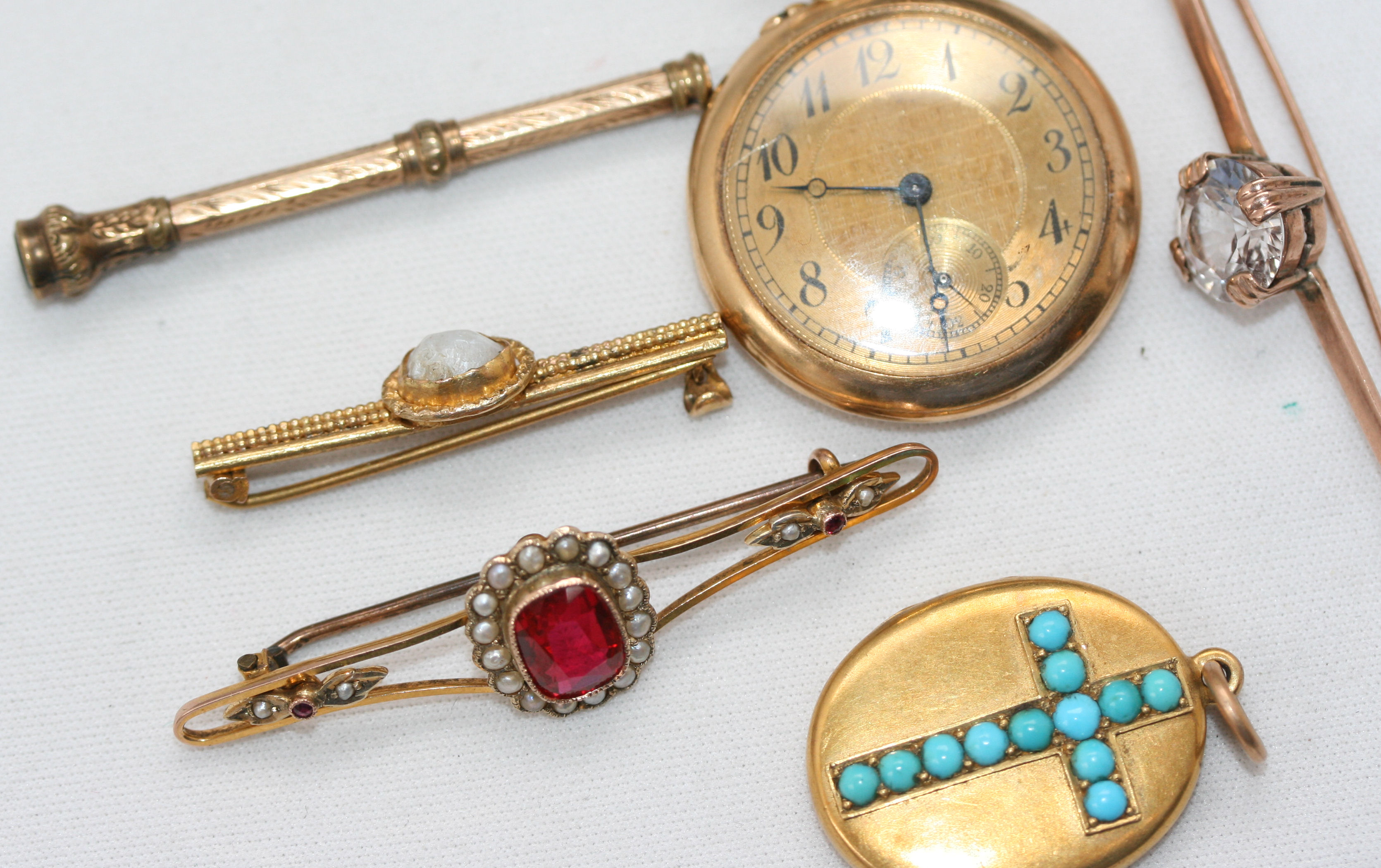 A group of three gem set bar brooches