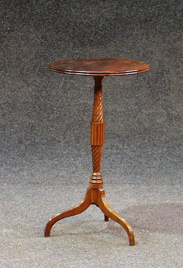 A mahogany tripod table